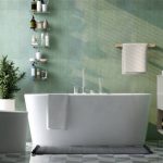 Modern and luxury design bathroom with bathtub, toilet bowl, vanity, washbasin, shelf and towel rail in sunlight from window on green granite wall and tile floor  for cleaning, toiletries product display background